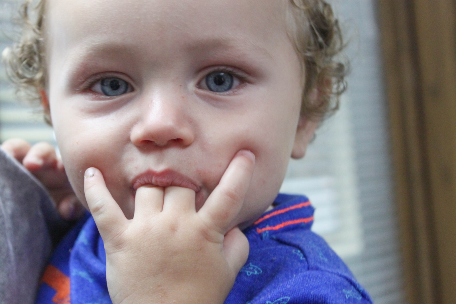 A curious toddler exploring with his fingers at the mouth